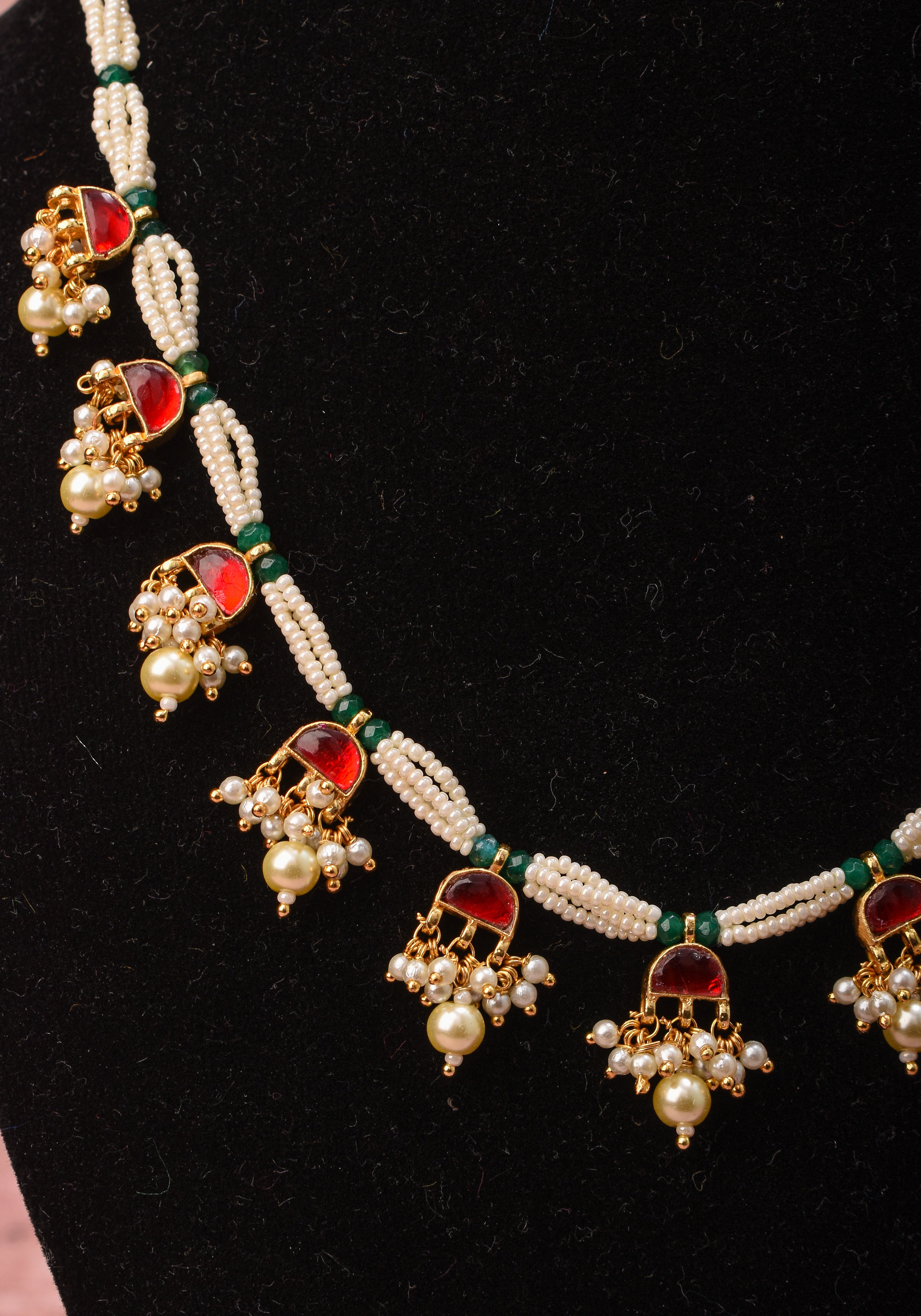 Lightweight Jadau Necklace Set with eleven dangling red stones and matching earrings