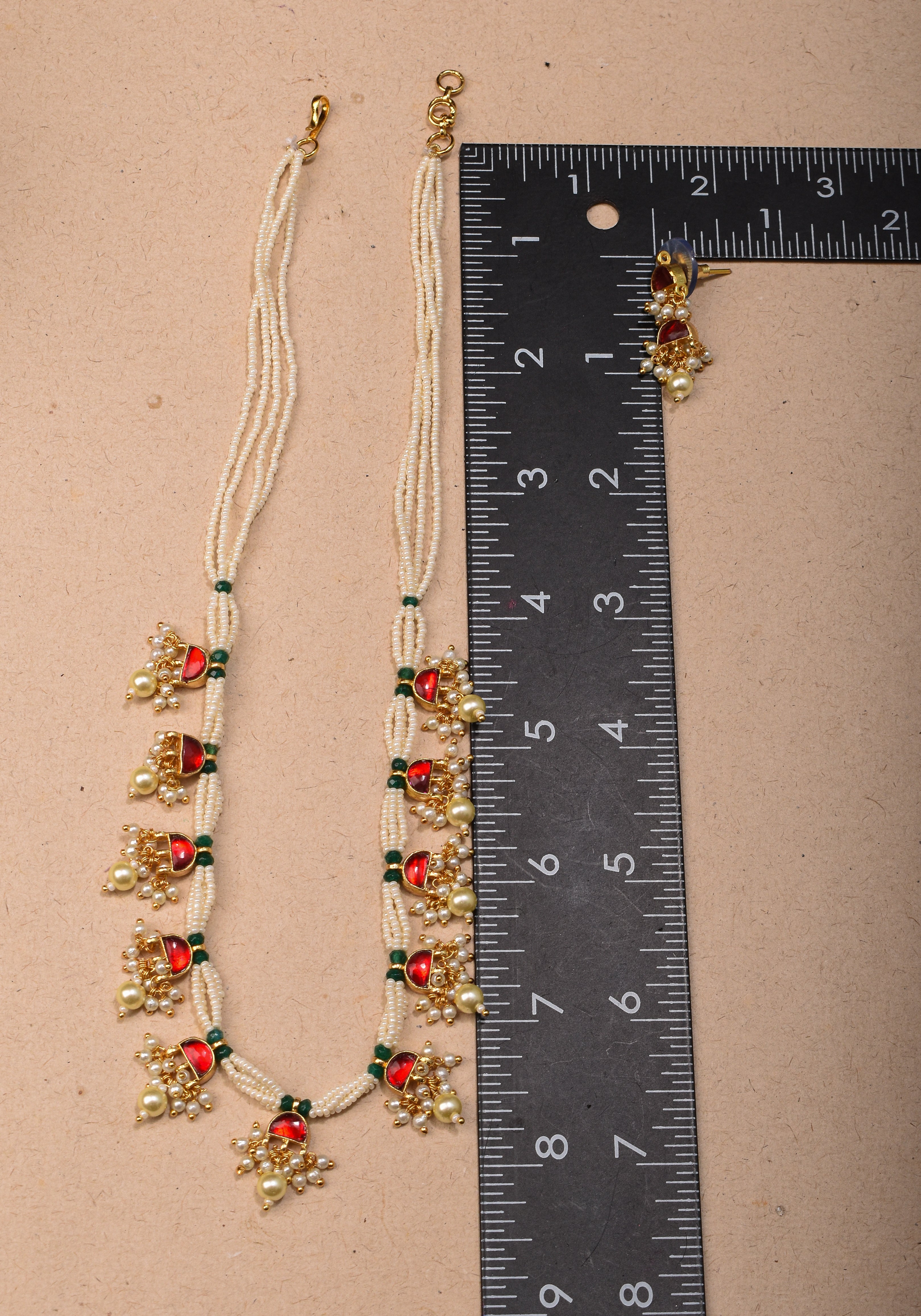 Lightweight Jadau Necklace Set with eleven dangling red stones and matching earrings