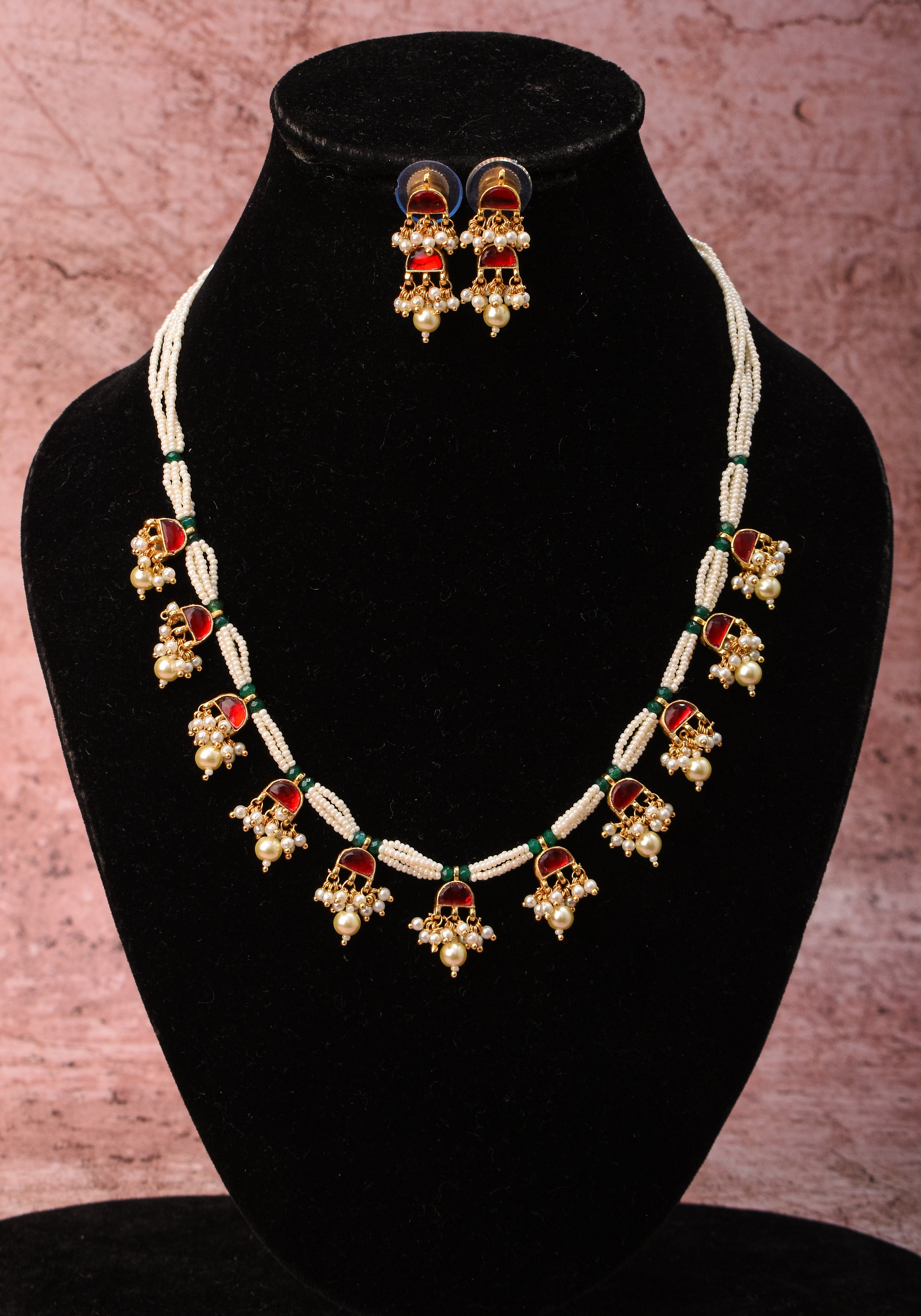 Lightweight Jadau Necklace Set with eleven dangling red stones and matching earrings