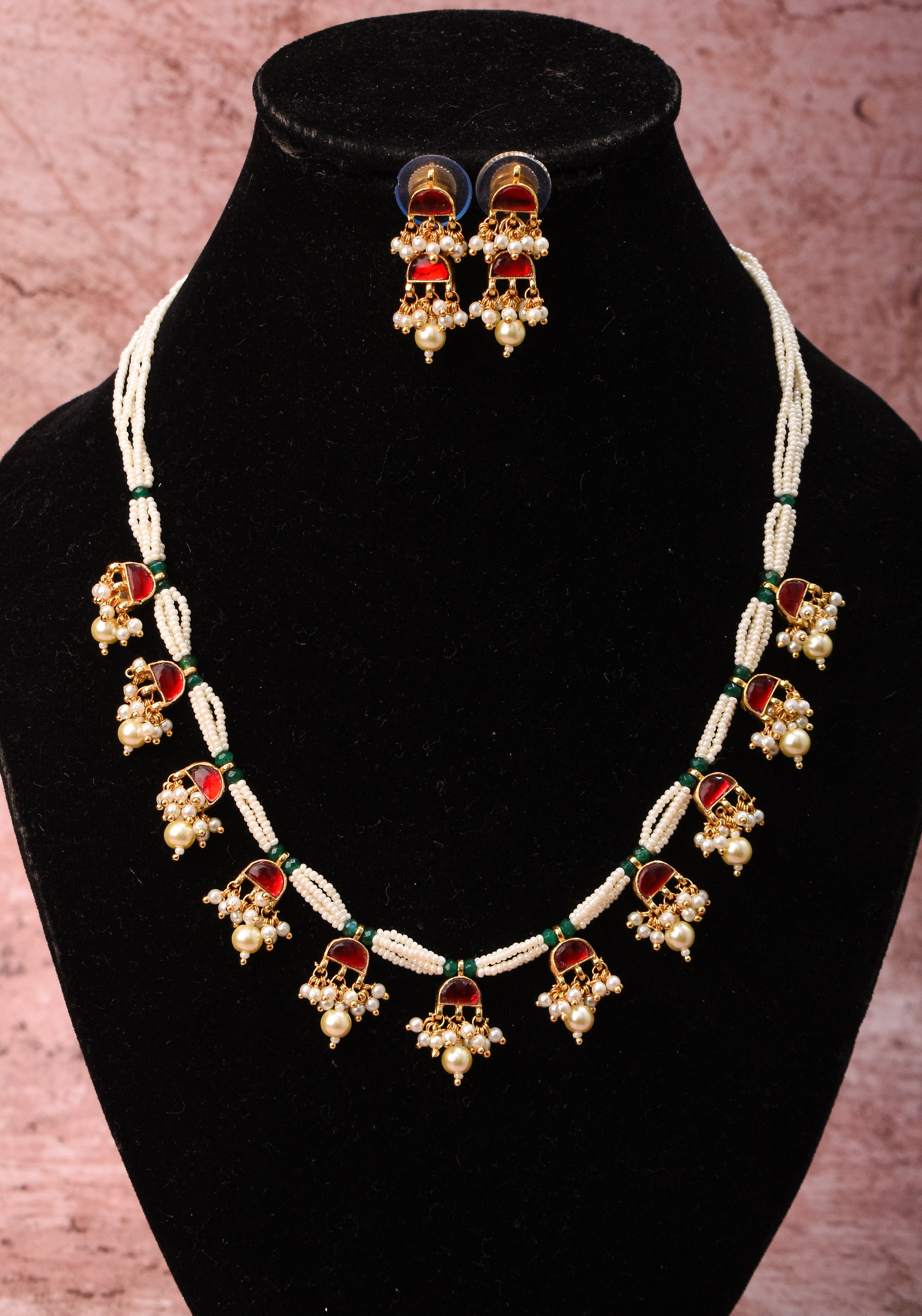 Lightweight Jadau Necklace Set with eleven dangling red stones and matching earrings