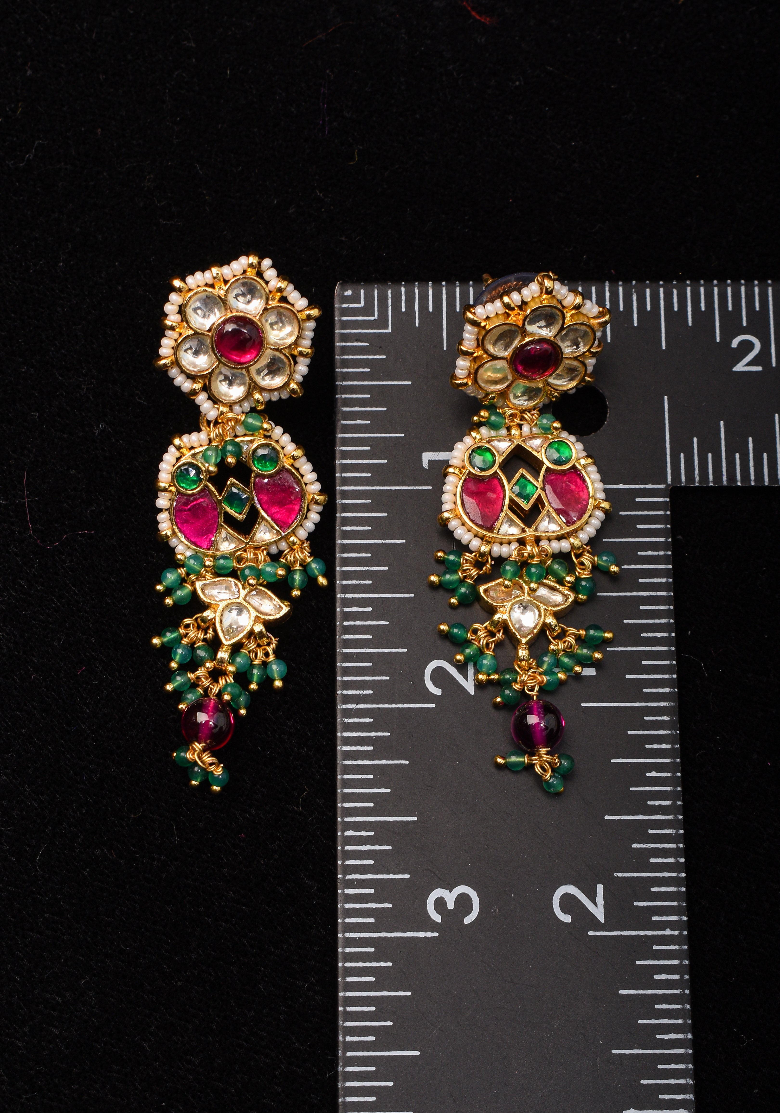 Earrings with flower  embedded in Jadau technique and dangling beads