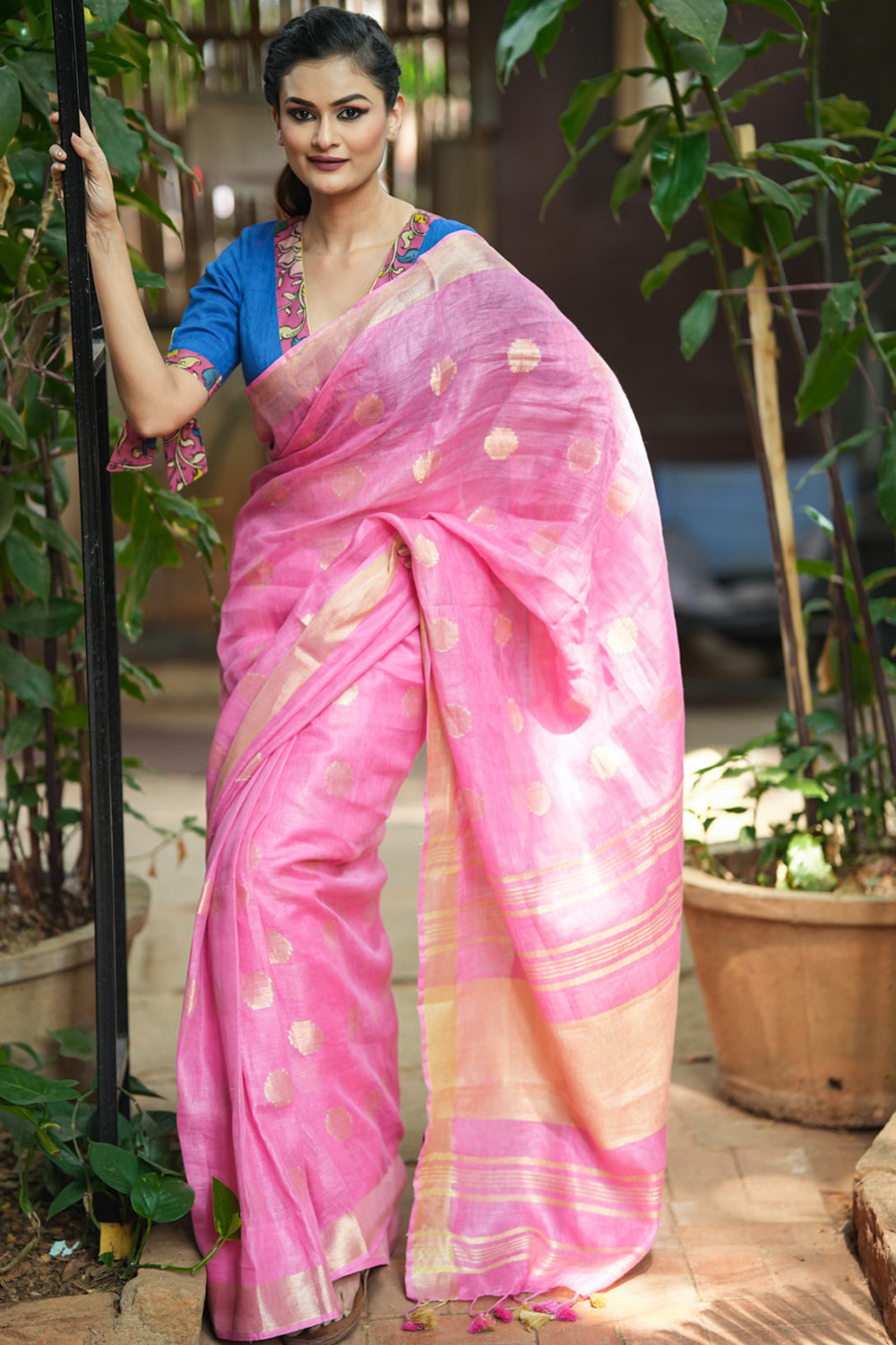 Carnation pink linen saree with woven polka dots.