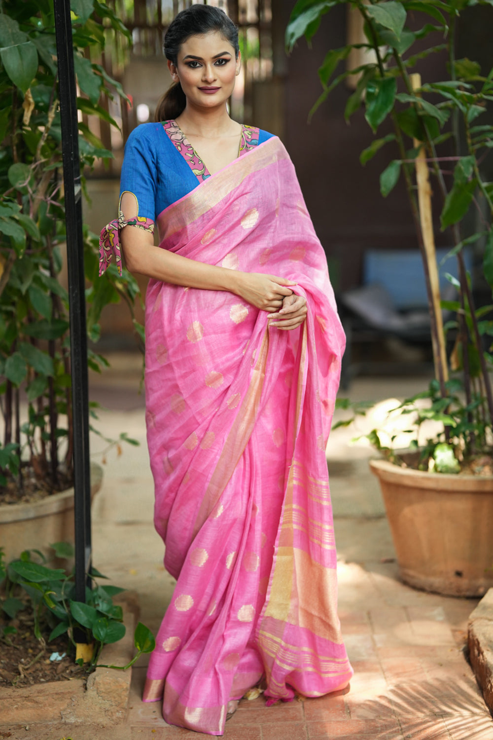 Carnation pink linen saree with woven polka dots.