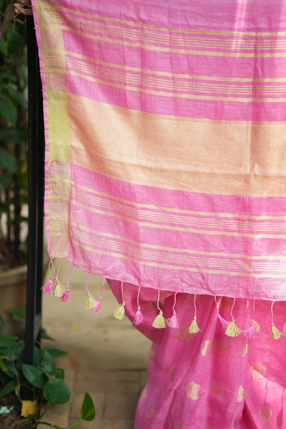 Carnation pink linen saree with woven polka dots.