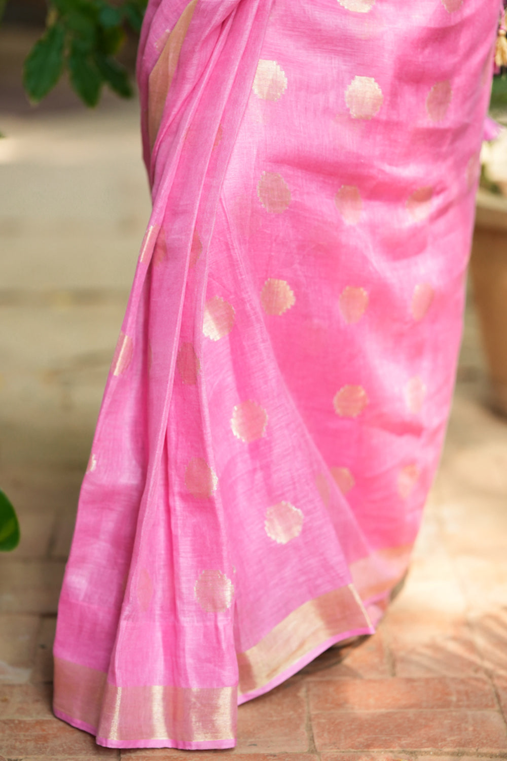 Carnation pink linen saree with woven polka dots.