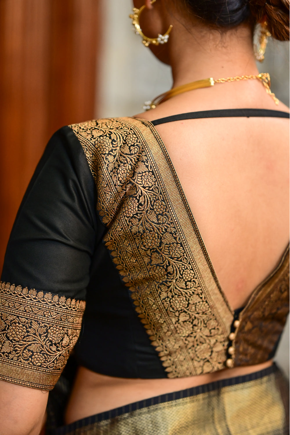 Black dupion deep V neck blouse with  antique tone zari detailing.